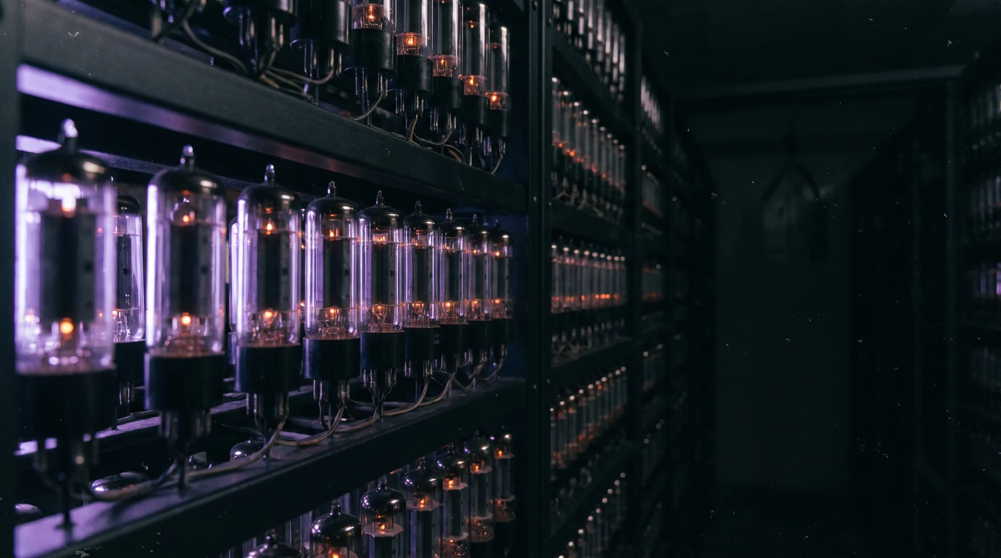 Rows of glowing vacuum tubes in a metal rack.